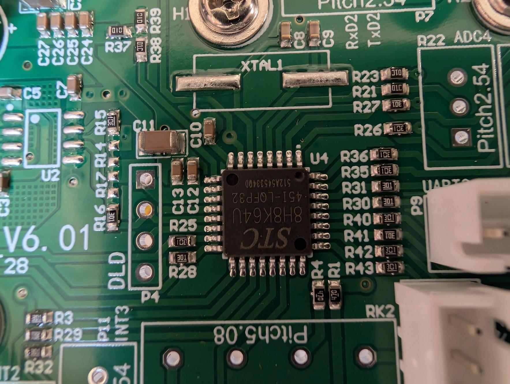 June 23: STC 8H8K64U microcontroller in LQFP-32 package. Markings: 512A54533400 / 451-LQFP32 / 8H8K64U / STC. All turntable logic — IR decode, motor sequencing, speed, beep — runs on this chip.